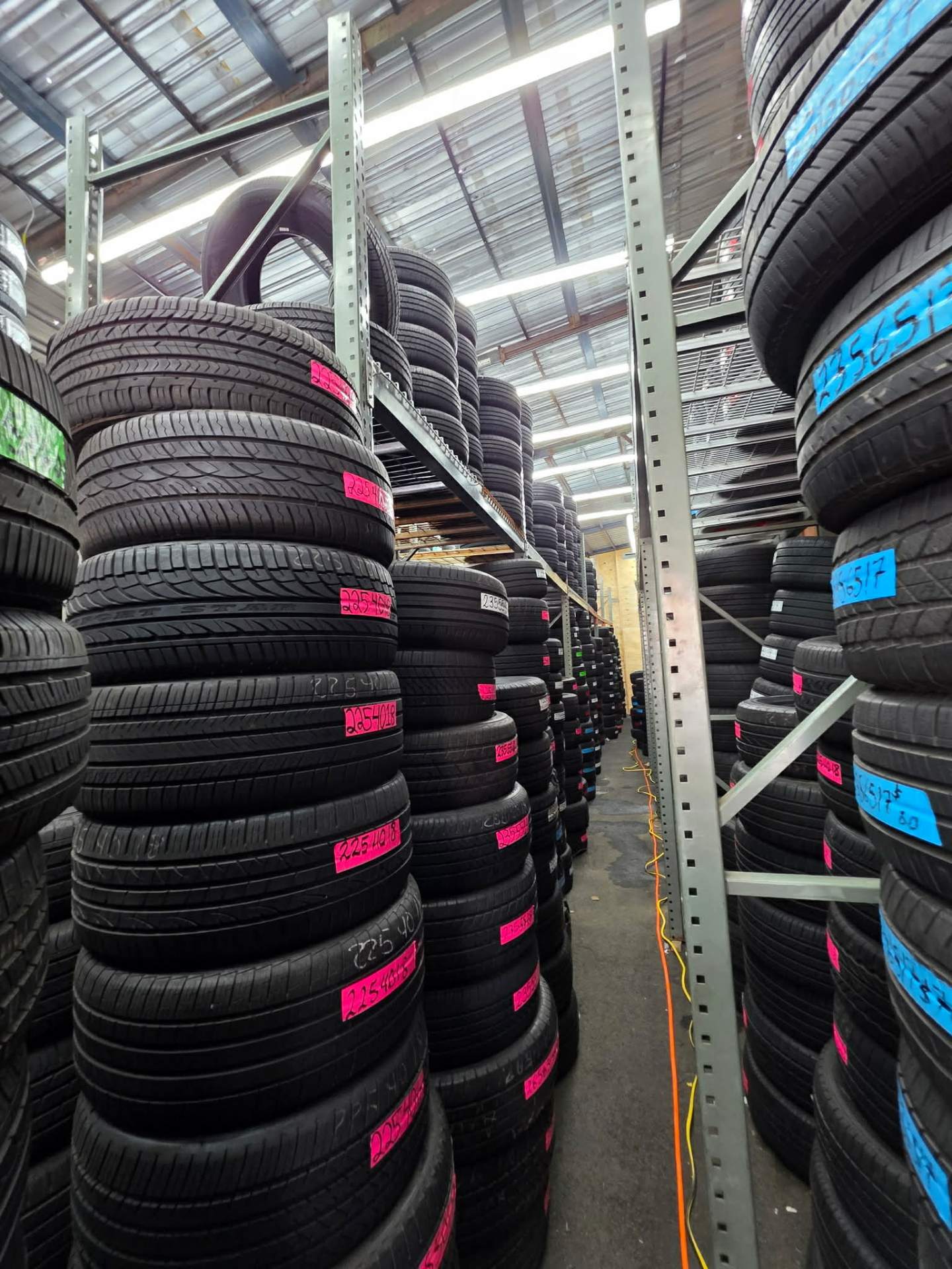 Warehouse stacked with new and used tires in every size